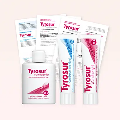 Packshot Tyrosur-Produkte mit Packungsbeilagen im Hintergrund
